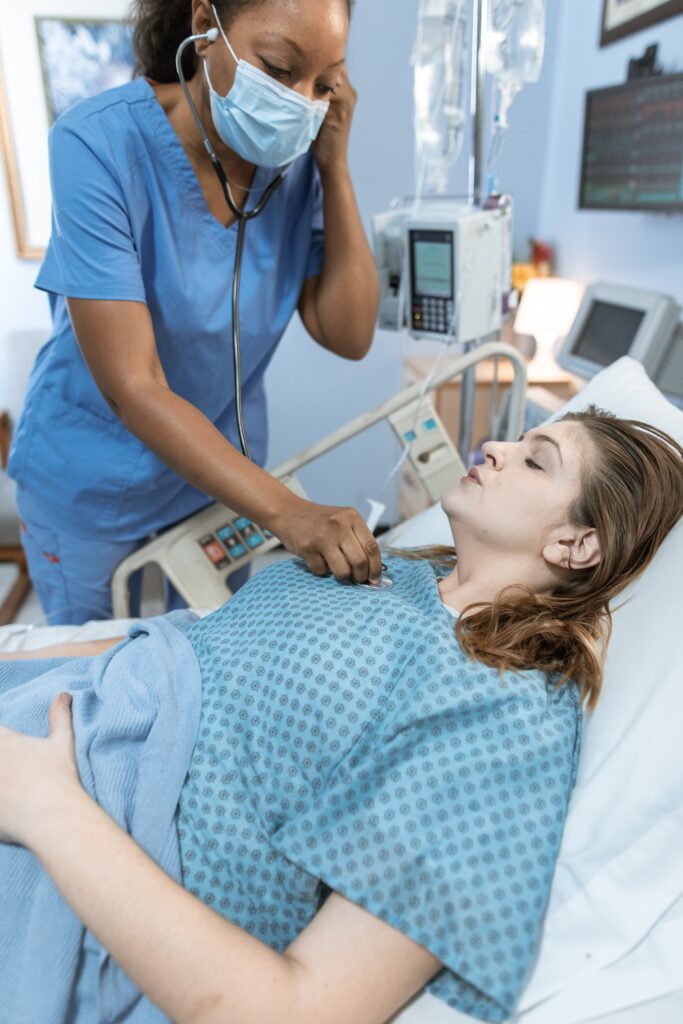 A woman with a nursing degree checking on a patient